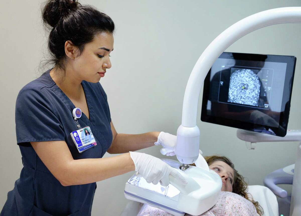 Ultrasonographer Sara Delgoshaei operates an automated ultrasound machine's transducer during a demonstration at Albany Medical Center's South Clinical Campus Wednesday Oct. 11, 2017 in Albany, NY. (John Carl D'Annibale / Times Union)