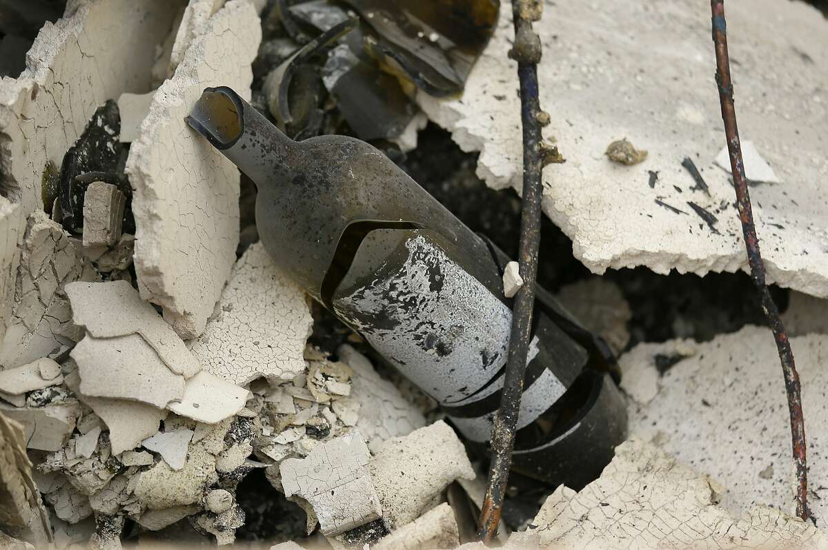 The remains of a burned bottle of wine are seen at the Signorello Estate winery Tuesday, Oct. 10, 2017, in Napa. Worried California vintners surveyed the damage to their vineyards and wineries Tuesday after wildfires swept through several counties whose famous names have become synonymous with fine food and drink.