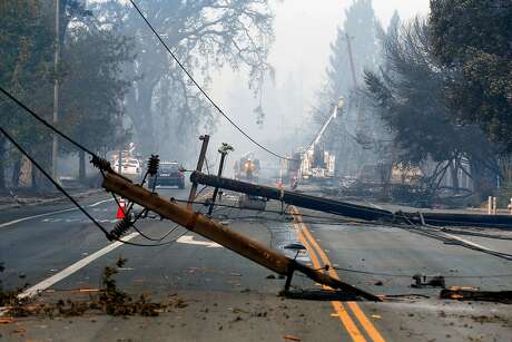 Utility crews begin the task of replacing the downed lines along Old Redwood Road in Santa Rosa, Ca. on Tuesday October 10, 2017. Massive wildfires ripped through Napa and Sonoma counties, destroying hundreds of homes and businesses on Monday morning.