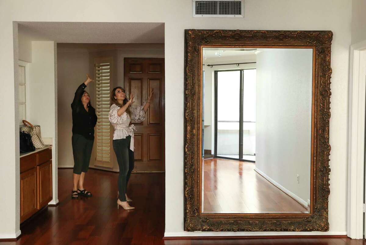 Mara Reid, left, tours a West University condo that her sister recently purchased for her mother, with her real estate agent Ellie Riney. They were going to meet with Reid's contractors to discuss changes to the condo.