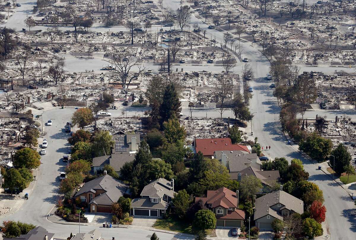 Homes that appear undamaged by Sunday night's firestorm remain near others that burned to the ground in the Coffey Park neighborhood in Santa Rosa, Calif. on Wednesday Oct. 11, 2017.