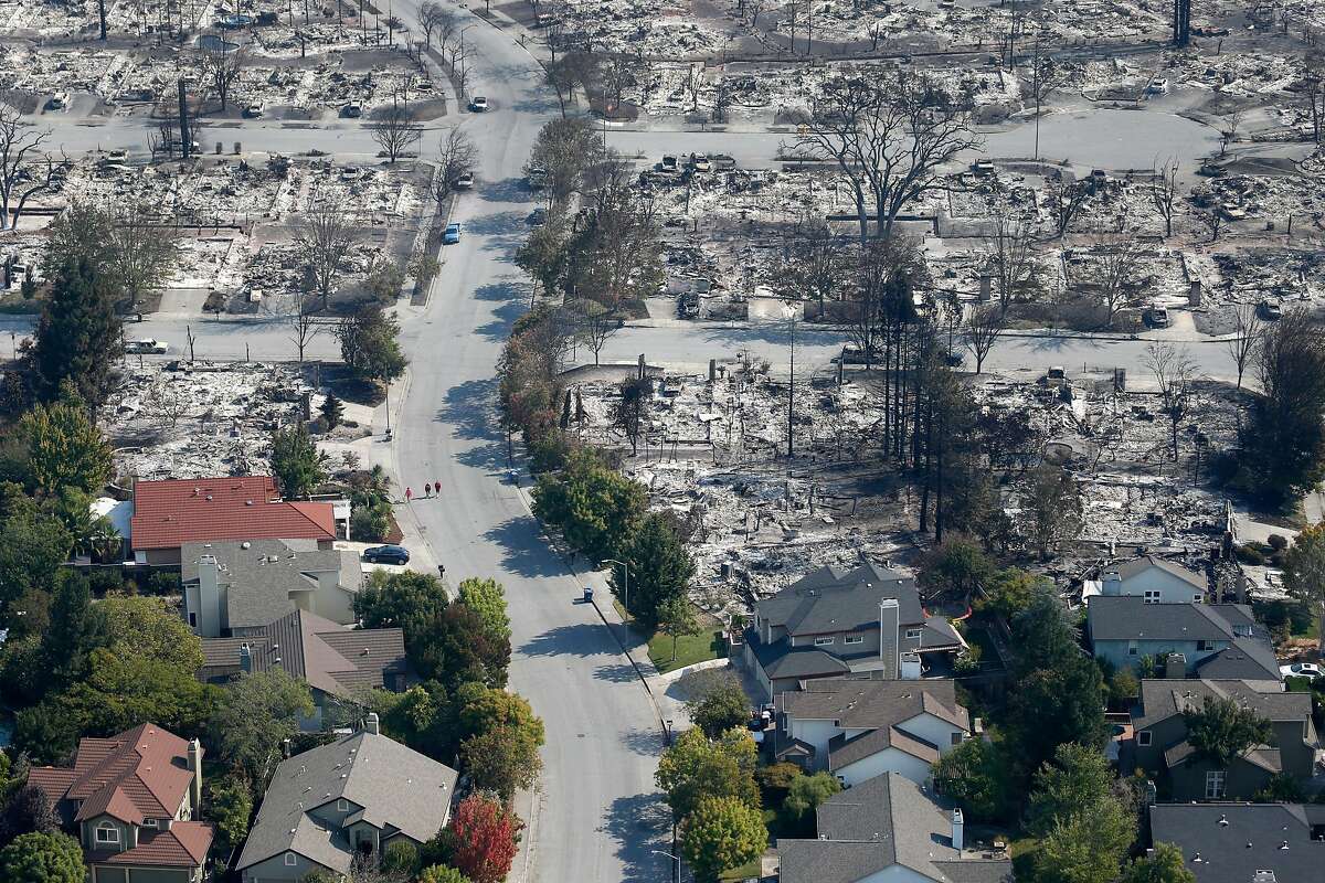 Homes that appear undamaged by Monday morning's firestorm remain near others that burned to the ground in the Coffey Park neighborhood in Santa Rosa, Calif. on Wednesday Oct. 11, 2017.