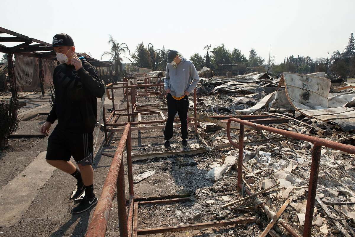 Seniors Deric Younce and Tyler Botteri (left to right) look through the damage Tubbs Fire inflicted on Cardinal Newman High School in Santa Rosa, Ca. on Wednesday, October 11, 2017. Both boys are athletes at the school.