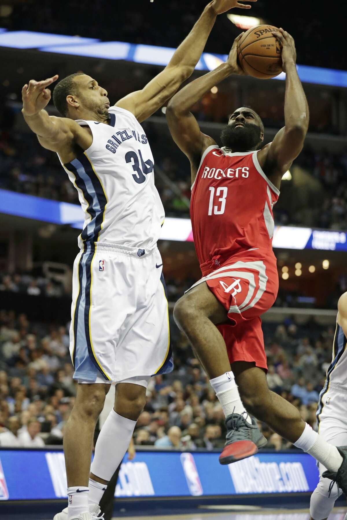 Memphis Grizzlies forward Brandan Wright (34) tries to block Houston Rockets guard James Harden (13) from a layup attempt in the first half of an NBA preseason basketball game on Wednesday, Oct. 11, 2017, in Memphis, Tenn. (AP Photo/Rogelio V. Solis)