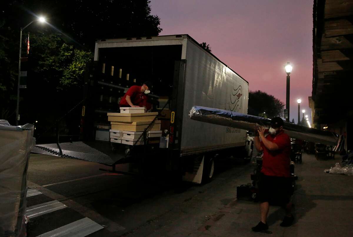 Workers move historic items from the Sonoma Barracks Oct. 11, 2017 in downtown Sonoma, Calif. California State Parks decided to move the items from the Barracks and Mission San Francisco Solano as a precautionary measure as fires burned beyond the town.