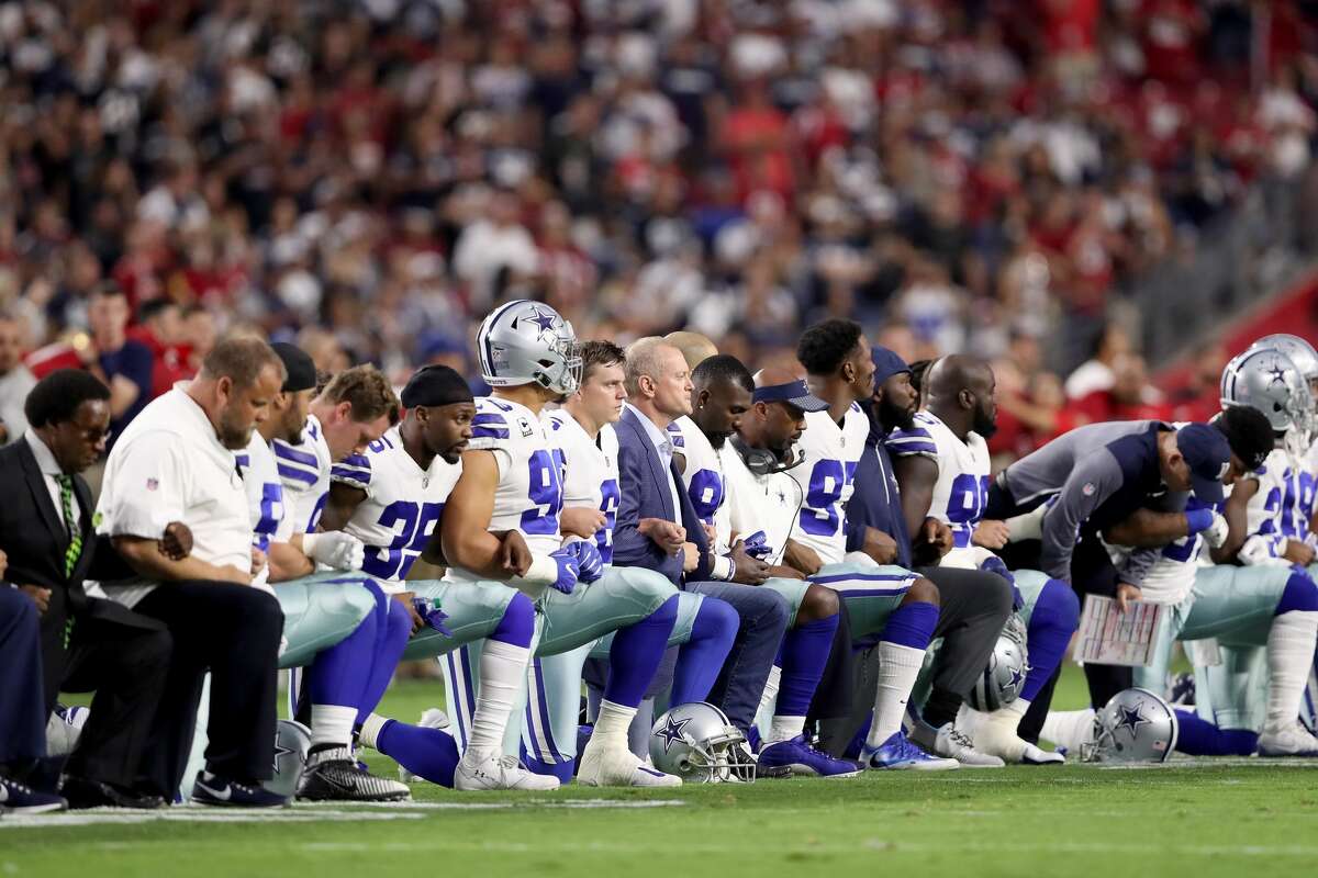 September 24, 2017 - Over 200 players kneeled in response to Trump's tweets. Above, members of the Dallas Cowboys link arms and kneel during the National Anthem before the start of the NFL on the following day in Glendale, Arizona.