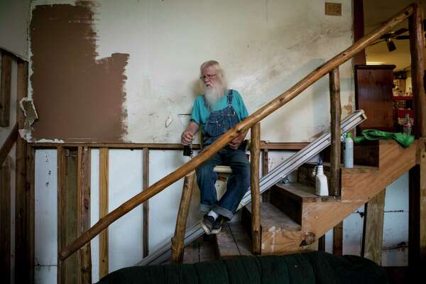 Jack D. Perkins rides down on a stair lift in his flood-damaged home in Conroe. Their home, which is downstream from Lake Conroe, flooded in 1994. When they rebuilt, they put their home on stilts. In the aftermath of Hurricane Harvey, their home flooded again. They are part of a group of homeowners, who live downstream from the Lake Conroe dam, who are suing the San Jacinto River Authority.