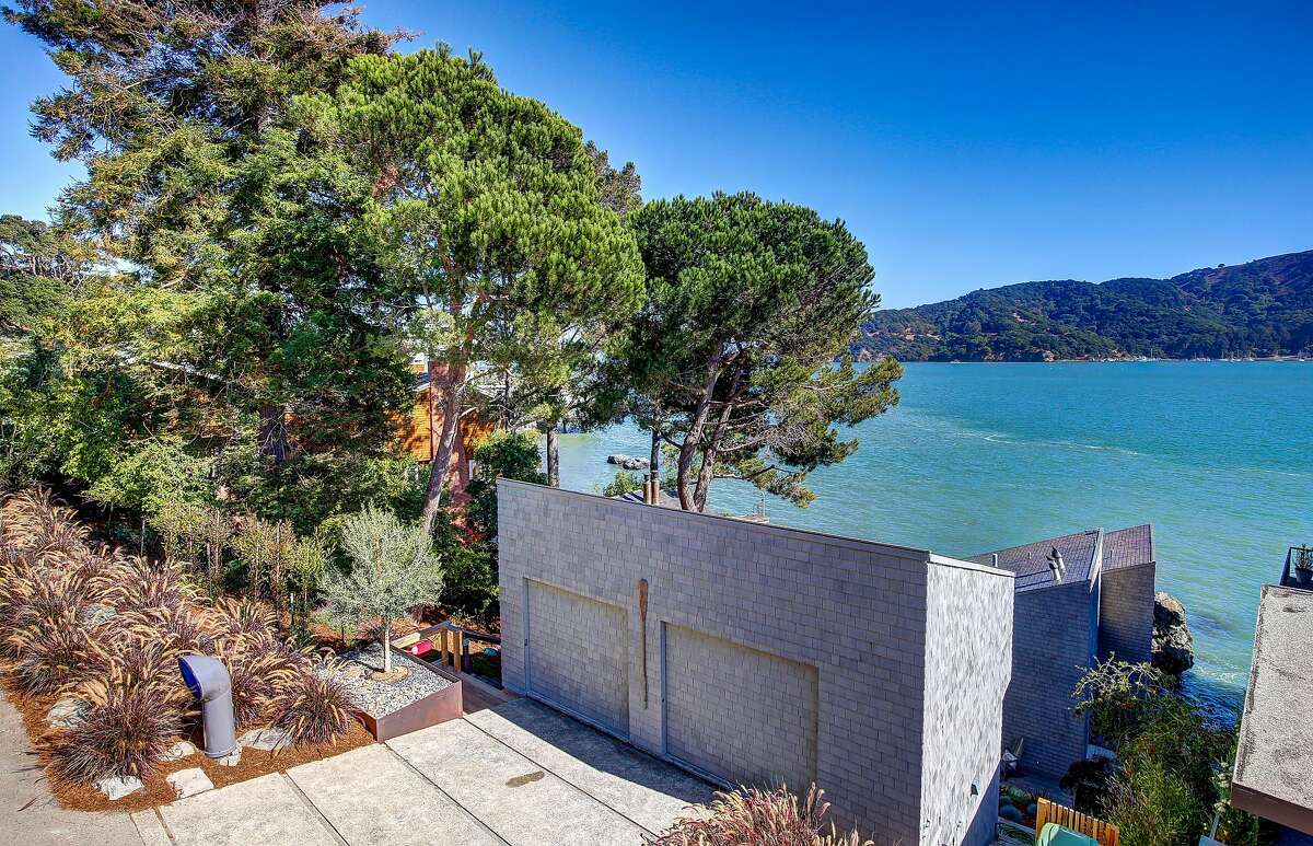 The Tiburon home rests on a downslope beside the water.�