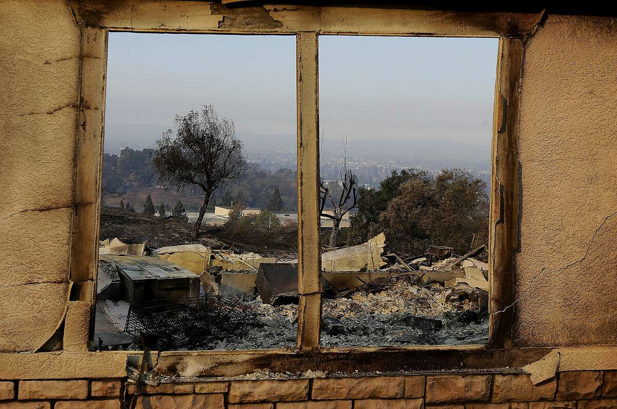 An exterior window frames a home destroyed by fires in Santa Rosa, Calif., Thursday, Oct. 12, 2017. Gusting winds and dry air forecast for Thursday could drive the next wave of devastating wildfires that are already well on their way to becoming the deadliest and most destructive in California history. (AP Photo/Jeff Chiu)