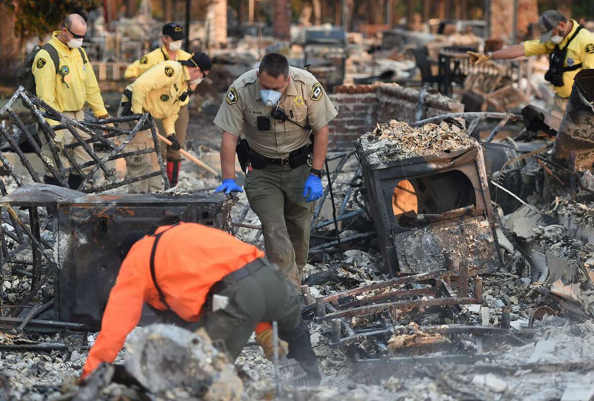 A search and rescue team searches for bodies at a property where a person was reported missing in Santa Rosa, California on October 12, 2017. Hundreds of people are still missing in massive wildfires which have swept through California killing at least 26 people and damaging thousands of homes, businesses and other buildings.