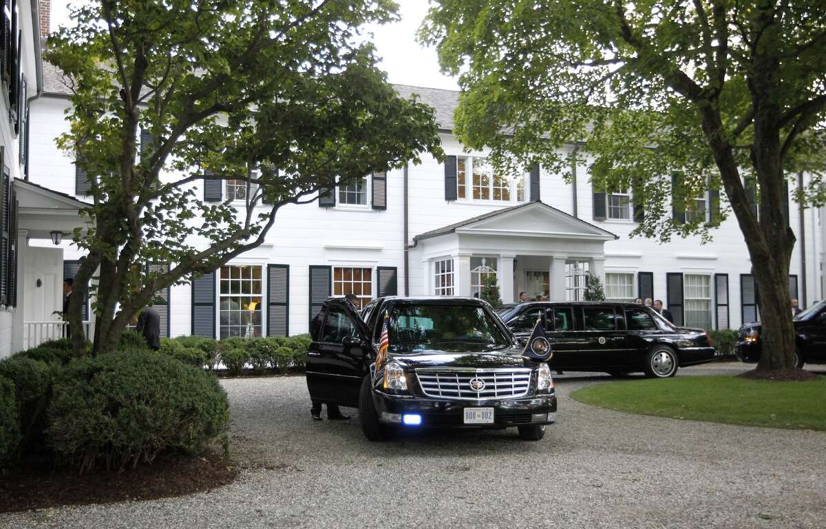 Limousines and motorcade vehicles for President Barack Obama are seen parked in the driveway outside the residence of movie producer Harvey Weinstein and fashion designer Georgina Chapman, Monday, Aug., 6, 2012 in Westport, Conn.