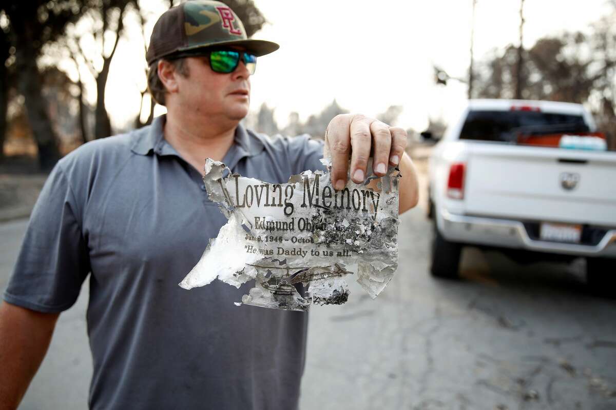 A man shows a burnt paper after a wildfire moved through the area in Santa Rosa and Napa Valley in California, United States on October 13, 2017. Massive out-of-controls wildfires have claimed at least 31 people and destroyed 3,500 homes in Northern California as the deadliest in state history. (Photo by Tayfun Coskun/Anadolu Agency/Getty Images)