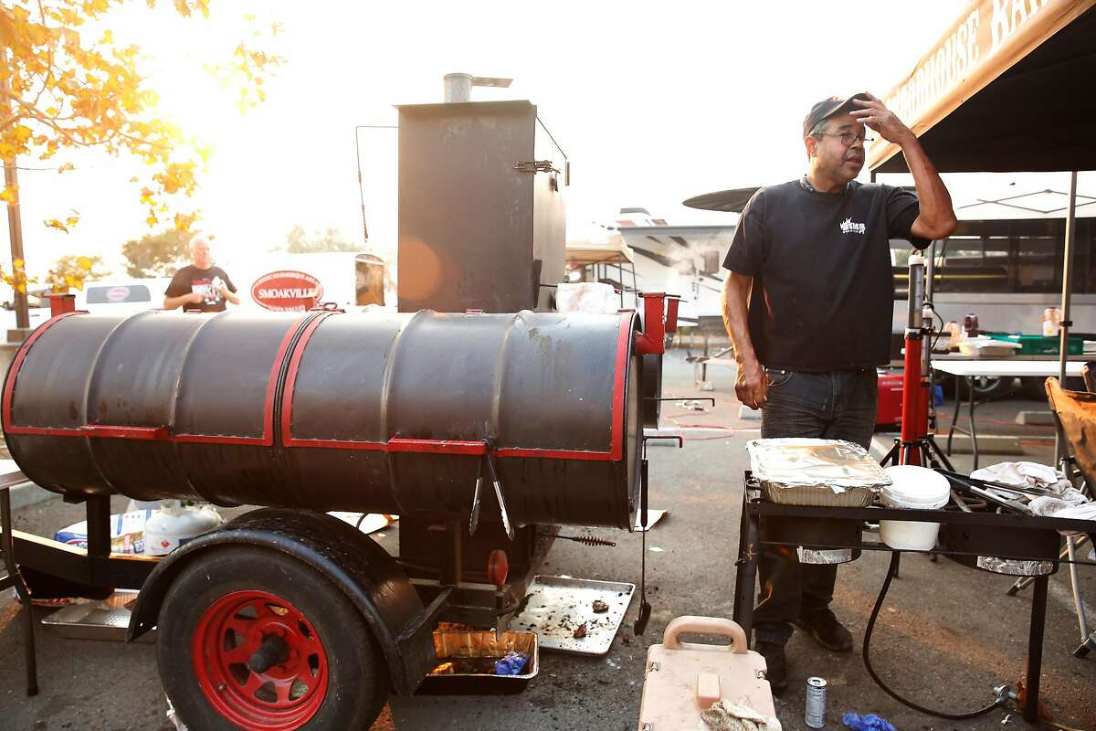 Woody Sims, owner Woody Sims Barbecue, works near his grill at an Operation BBQ Relief site on Thursday, Oct. 12, 2017 in Napa.
