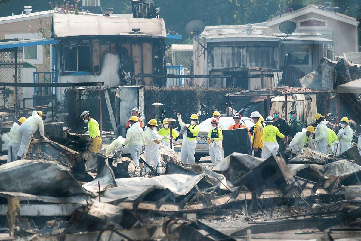 Search and rescue workers search for Tubbs fire victims at Journey's End Mobile Home Park on Friday, Oct. 13, 2017, in Santa Rosa, Calif. According Sgt. Dave Thompson, in charge of search and rescue operations for the Sonoma County Sheriffs Office, crews have recovered another body at the site.