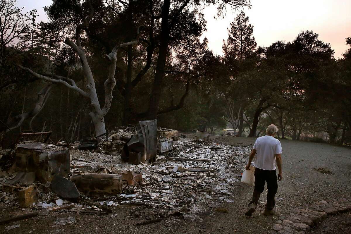 Richard Horwath walks back to his tractor after putting out a hot spot on his neighbor's property Oct. 12, 2017 in Calistoga, Calif. The Horwath's bought the property 30 years ago, but they only finished building their new home in 2010. Richard Horwath got up to go to bed when first smelled smoke in their bedroom, he then ran outside and saw the sky was orange. The power went out right after Richard grabbed his firehose that could have pumped hundreds of gallons of water a minute and that was when he and Kathy decided they needed to go. Neighbors were driving up and down the road outside, frantically honking their horns and the wind was blowing hard in their direction. After pausing to close every window so as to keep embers out, the Horwath's left. As they began driving down the road, they started to hear "monstrous explosions" of nearby houses going up in flames. As the fire crested the ridge above their home, Richard said it sounded like a freight train. The two of them white-knuckle drove the whole way out towards Healdsburg, at one point having to drive through a vineyard to avoid downed trees. On highway 101, trees were falling left and right from the wind. An hour after they left, when they were heading down 101 past Santa Rosa, they could already see the fire making its way down Mark West Springs Rd towards the city. Though most of their neighbors homes were destroyed, their home made it.