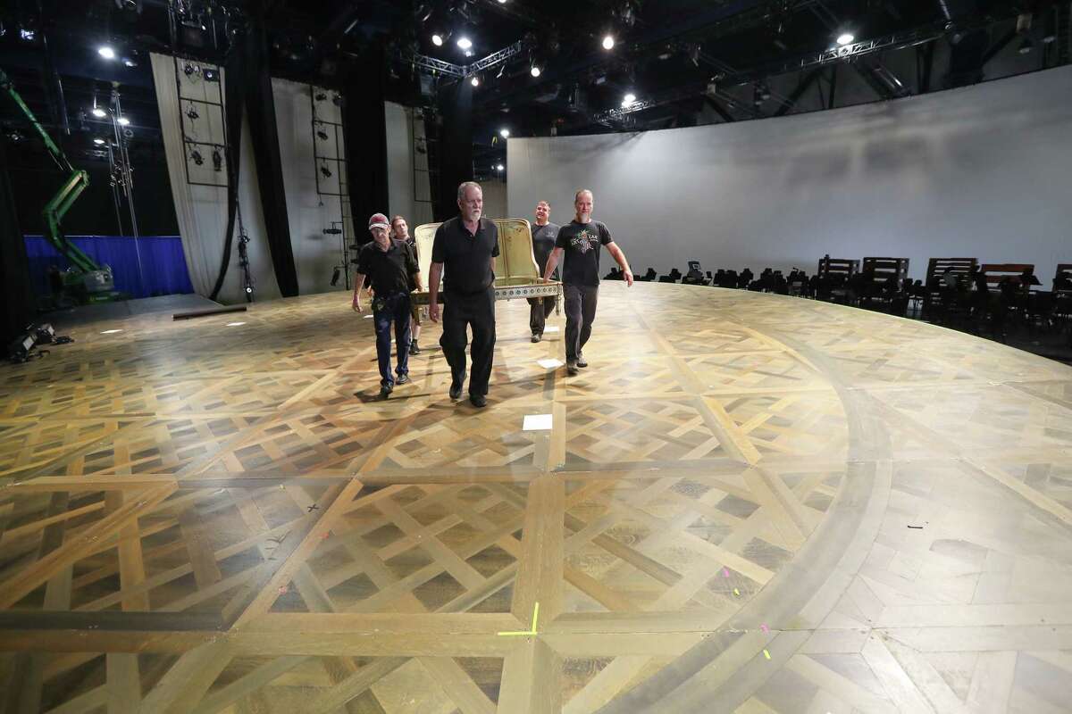 Stagehands move around sets during the transformation of a George R. Brown Convention Hall into a grand opera house is underway Wednesday, Oct. 11, 2017, in Houston. Houston Grand Opera moved to the George R. Brown Center Exhibition Hall A3, now titled the "HGO Resilience Theatre." ( Steve Gonzales / Houston Chronicle )