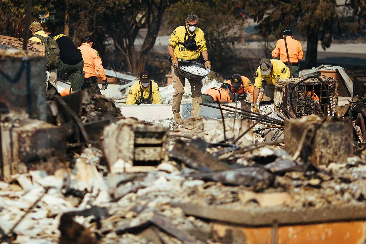 Search and rescue workers dig the rubble of a home on Millbrook Drive on Friday, Oct. 13, 2017, in Santa Rosa, Calif. Rosa, Calif.