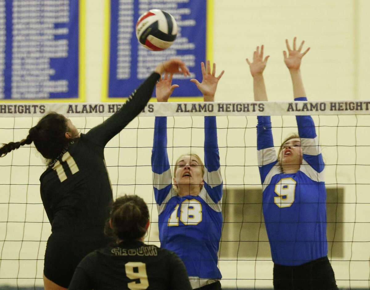 Alamo Heights' Abby Sanders (18) and Margaret Stell (09) attempt to block a shot by Seguin's Desiray Rodriguez (11) during girls volleyball at Alamo Heights on Friday, Oct. 13, 2017. The Sequin Lady Matadors defeated Alamo Heights Lady Mules, 3-2. (Kin Man Hui/San Antonio Express-News)