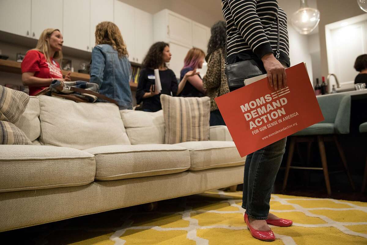 on Sunday, Oct. 8, 2017 in San Francisco, CA A woman holds a sign supporting Moms Demand Action for Gun Sense after hearing from the gun advocacy groups local leader, Catherine Stefani, who is also the SF County Clerk, during an informational meeting in the San Francisco home of Rhiana Maidenberg, on Sunday October 8, 2017.