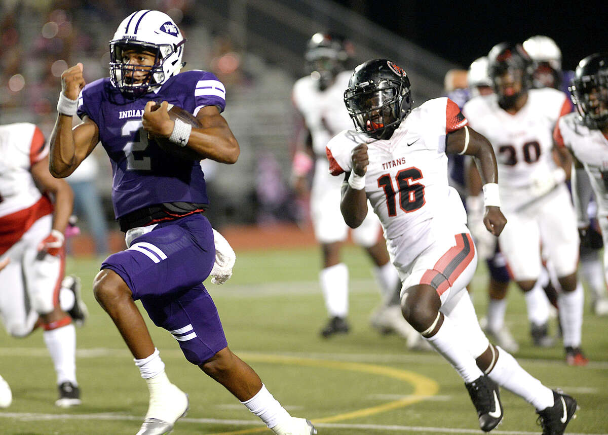 Port Neches - Groves' Roschon Johnson leaps past Port Arthur Memorial's defense as he carries the ball during their match-up Friday night at PNG. Both teams entered the field undefeated. Photo taken Thursday, October 12, 2017 Kim Brent/The Enterprise