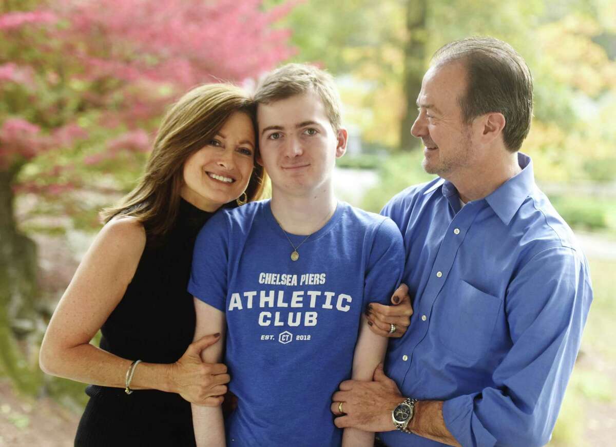 Andrea and Phil Marella pose with their son, Andrew, 18, at their home in Greenwich, Conn. Wednesday, Oct. 11, 2017. Andrew has a rare progressive genetic disorder called Niemann-Pick disease type C (NPC), which took the life of his sister, Dana, in 2013. The Marella's non-profit Dana?’s Angels Research Trust (DART), raises money to research the disease and is holding a benefit concert featuring country music star Hunter Hayes at The Palace Theatre in Stamford on Nov. 11.
