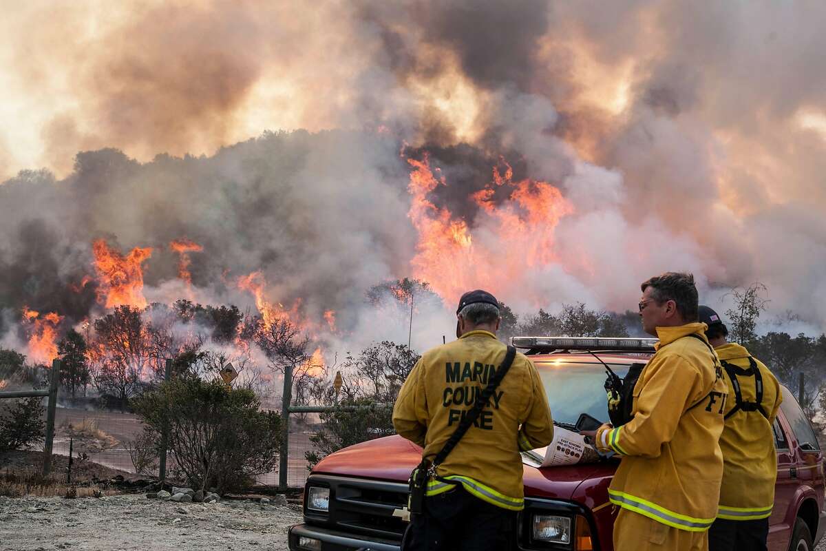Area command fire fighters accesses a blowup through a re-burn area along Wood Vally Rd after winds kicked up flames east of Sonoma, California, USA 14 Oct 2017.