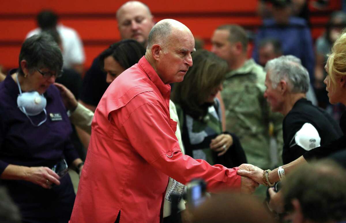 California Governor Jerry Brown greets a community member before a Sonoma County Fire Response and Recovery community meeting at Santa Rosa High School in Santa Rosa, Calif., on Saturday, October 14, 2017.