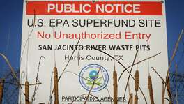 A sign warns the public about the EPA Superfund Site not to eat contaminated seafood caught from the water along Interstate 10 near the San Jacinto River east of Houston in Channelview.  ( Michael Paulsen / Houston Chronicle )