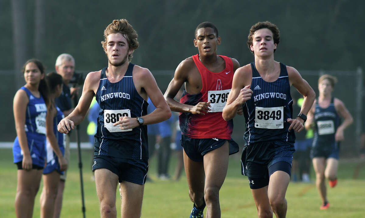Kingwood's Carter Storm, left, and Nick Majerus, right, bookend Atascocita's Worthington Moore, center, during the Varsity Boys race at the District 21-6A Cross Country Championship at Atascocita High School on Oct. 13, 2017. (Photo by Jerry Baker/Freelance)