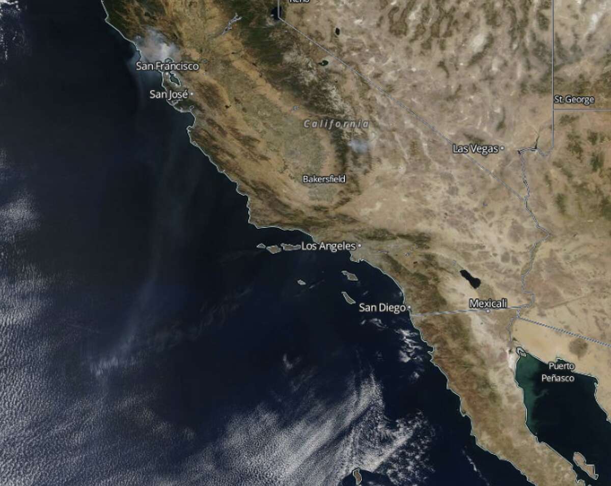 Aerial photos show smoke from the Wine Country fires billowing into the Pacific Ocean and traveling as far south as Mexico on Friday, Oct. 13. 