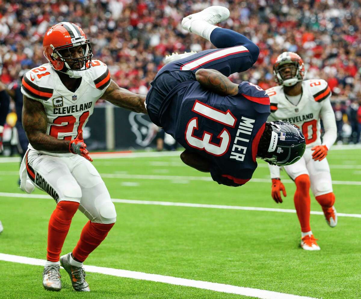 Houston Texans wide receiver Braxton Miller (13) flips into the end zone past Cleveland Browns cornerback Jamar Taylor (21) for a 1-yard touchdown reception during the second quarter of an NFL football game at NRG Stadium on Sunday, Oct. 15, 2017, in Houston.