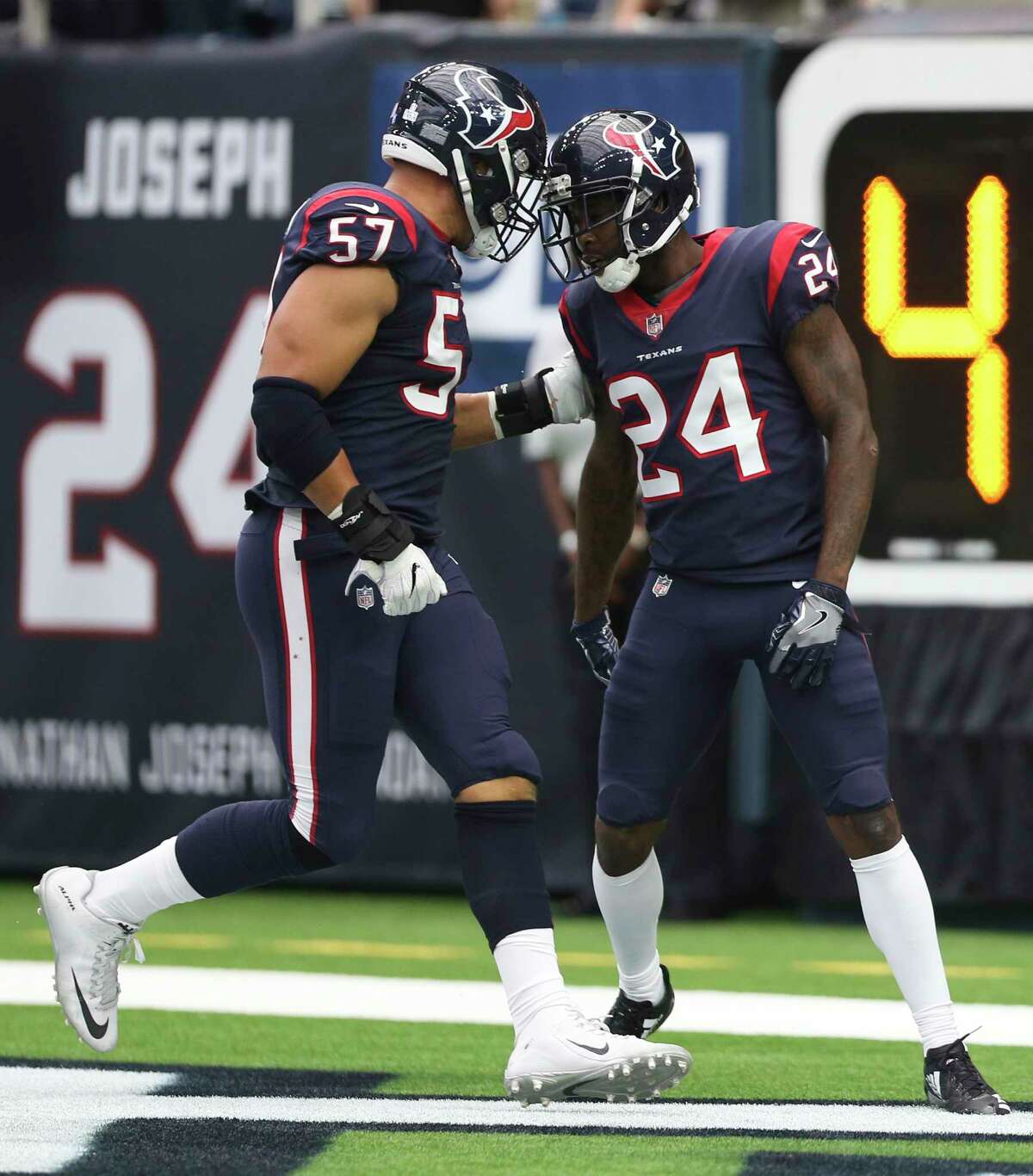 Houston Texans cornerback Johnathan Joseph (24) and linebacker Brennan Scarlett (57) celebrate Joseph's interception and touchdown during the second quarter of an NFL football game at NRG Stadium on Sunday, Oct. 15, 2017, in Houston.