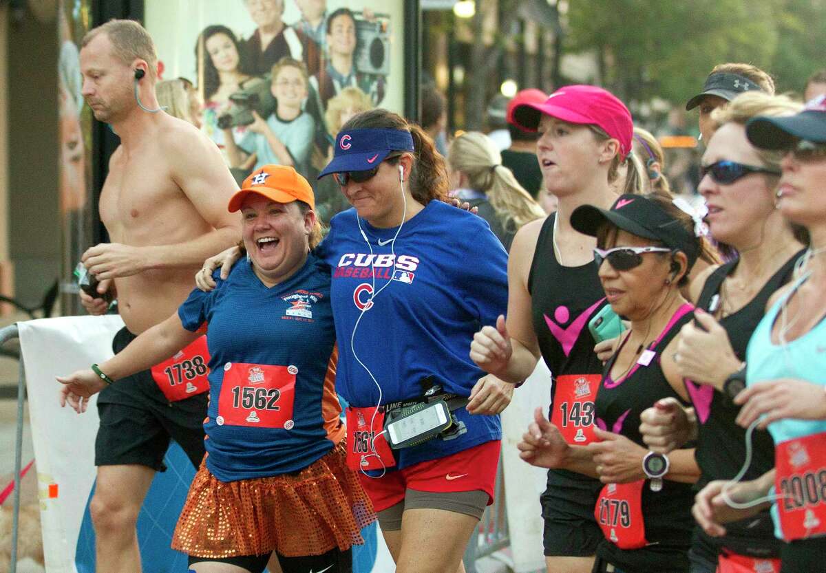 A pair of women may be fans of different baseball teams, but that didn't stop them from rooting for each other during Saturdays race.