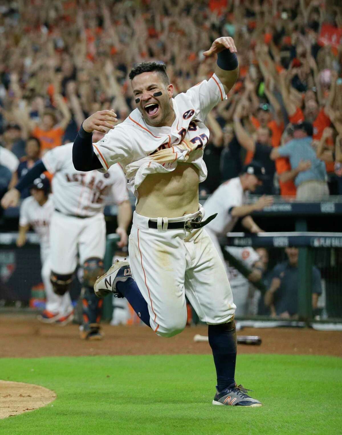 Houston Astros' Jose Altuve reacts after scoring the game-winning run during the ninth inning of Game 2 of baseball's American League Championship Series against the New York Yankees Saturday, Oct. 14, 2017, in Houston. The Astros won 2-1 to take a 2-0 lead in the series. (AP Photo/Tony Gutierrez)