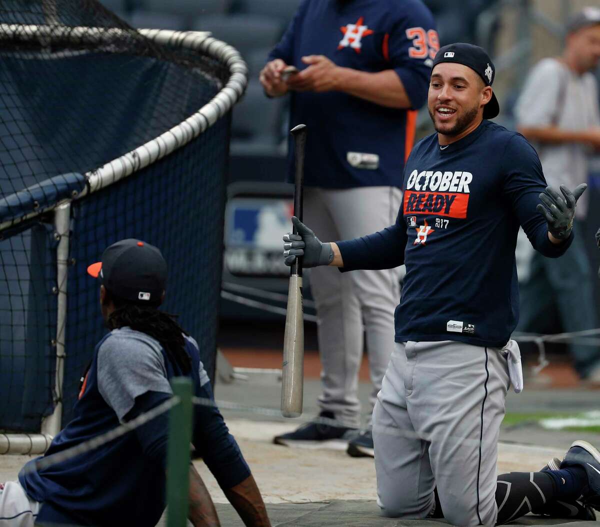 Houston Astros center fielder George Springer talks with Cameron Maybin during the Astros workout at Yankee Stadium, Sunday Oct. 15, 2017, in Houston.