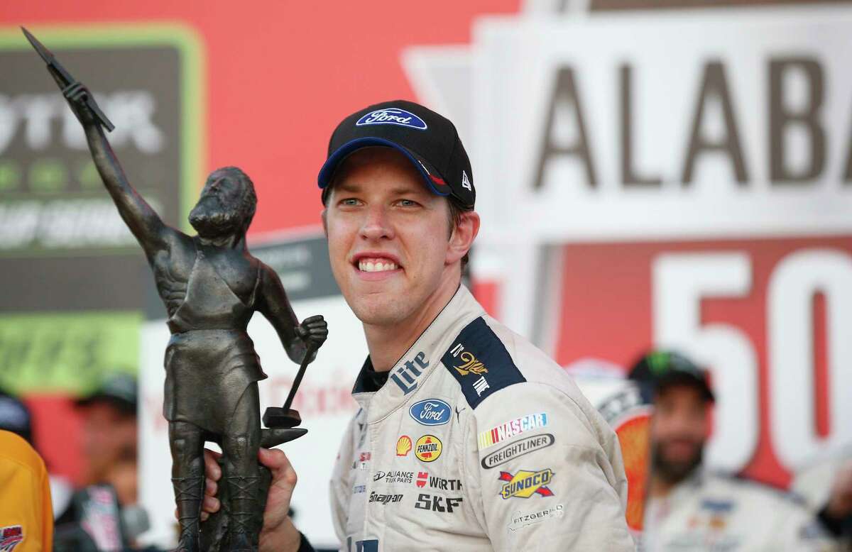 NASCAR driver Brad Keselowski holds up the trophy after the Alabama 500 at Talladega Superspeedway, Sunday, Oct. 15, 2017, in Talladega, Ala. (AP Photo/Brynn Anderson)