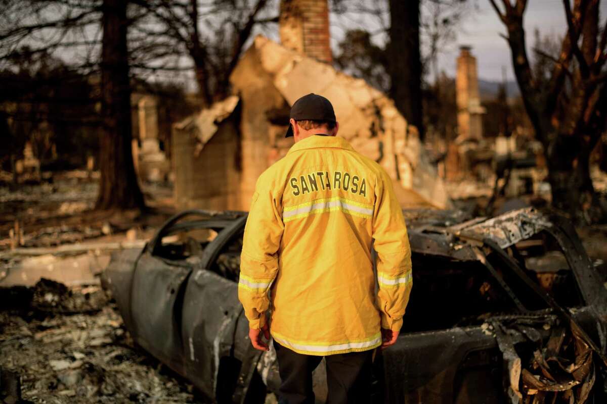 Santa Rosa Assistant Fire Marshal Paul Lowenthal walks through his Oxford Ct. residence, which burned during the Tubbs fire, on Thursday, Oct. 12, 2017, in Santa Rosa.
