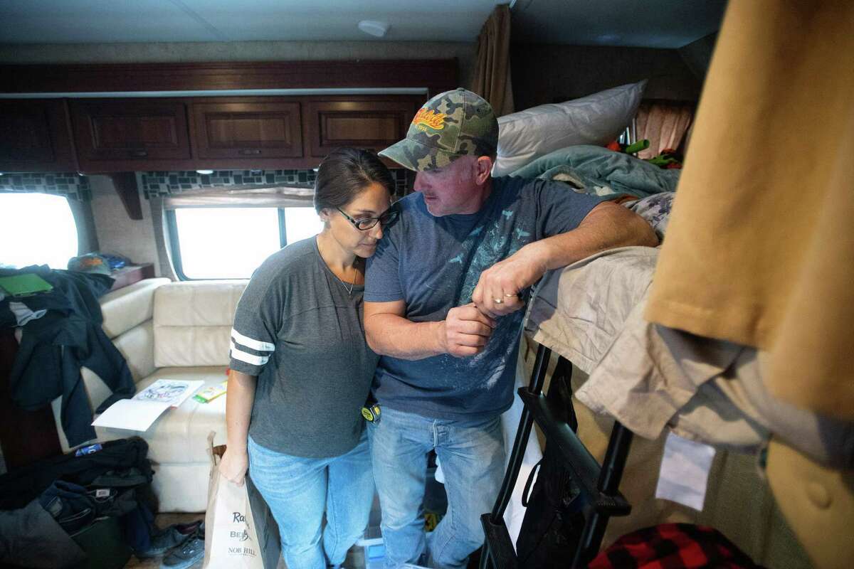 Caroll Niel leans on her husband, firefighter Tony Niel, in the motorhome where they are staying following the Tubbs fire on Friday, Oct. 13, 2017, in Forestville, Calif.