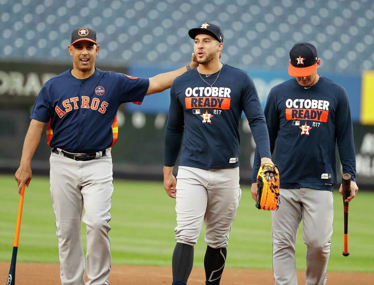 Astros bench coach Alex Cora, left, with outfielder George Springer during Sunday's workout at Yankee Stadium, is expected to interview for at least three managerial openings.
