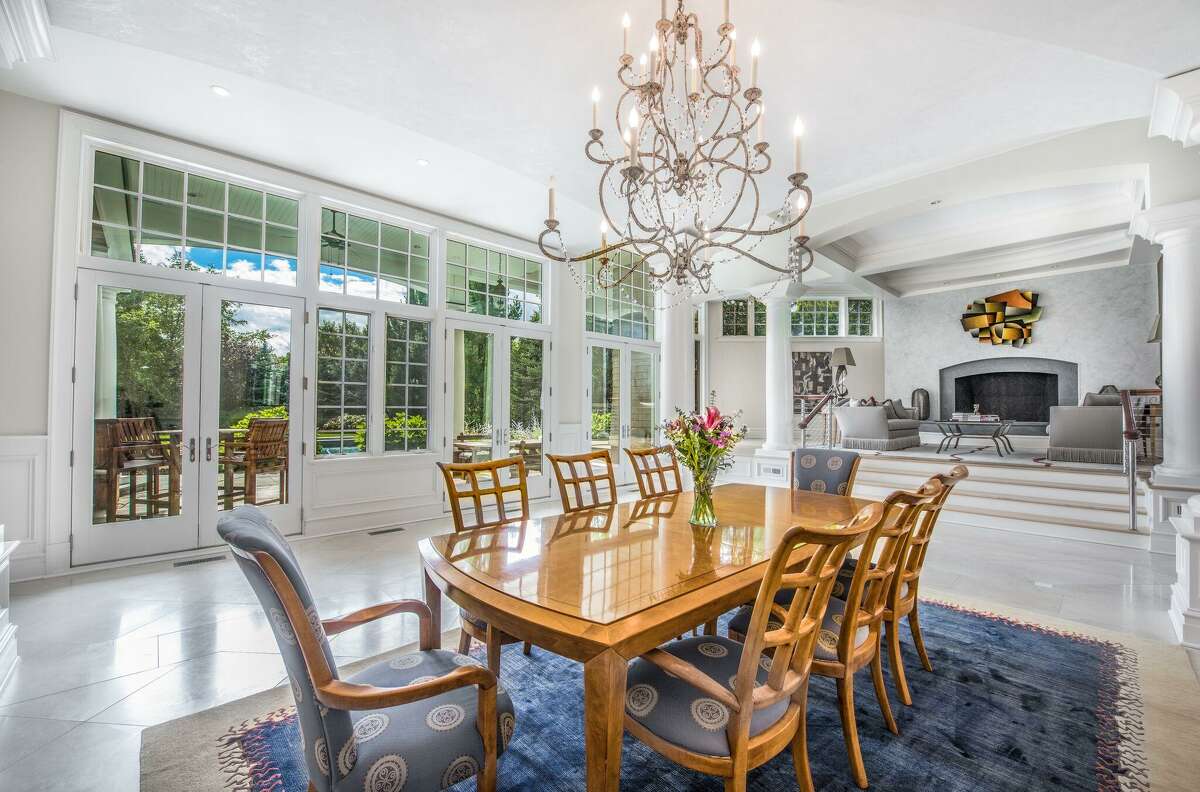 The formal dining room is open to the living room, both of which has French doors to decks.