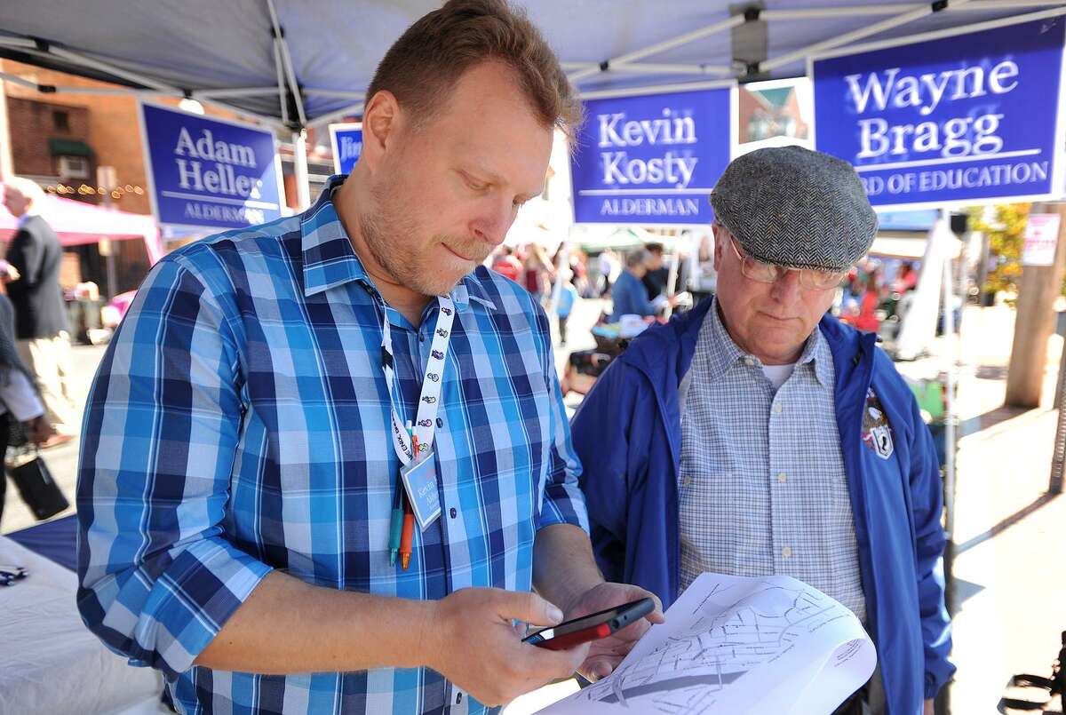 Democratic alderman candidate Kevin Kosty, left, looks at a map of downtown Shelton during a day of canvassing for votes in Shelton, Conn. on Sunday, October 1, 2017.