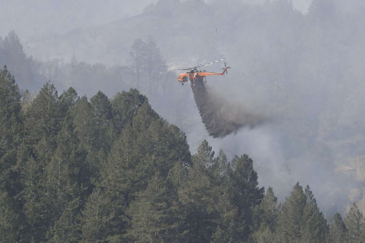 Fire along the ridge in Oakville being doused by helicopters on Monday, Oct. 16, 2017 in Oakville, CA.