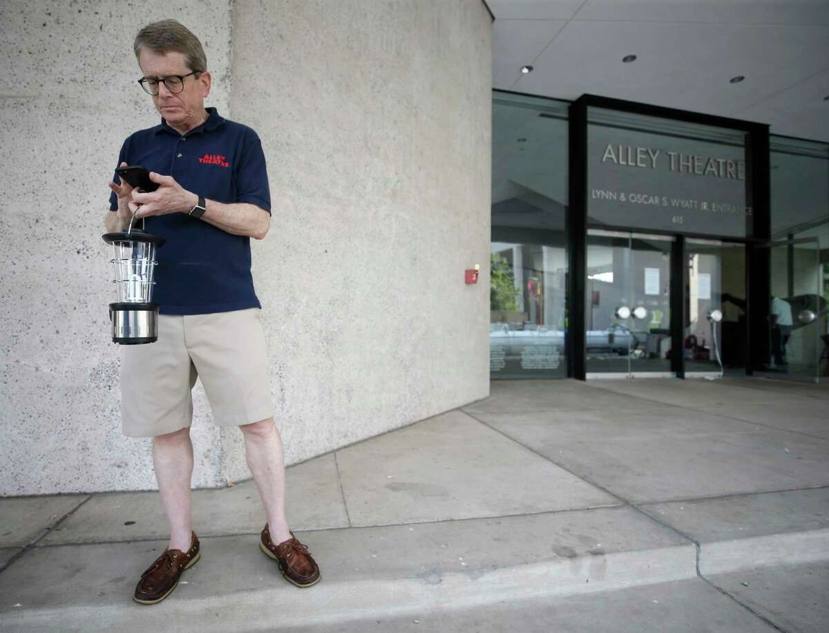 Dean Gladden, managing director of the Alley Theatre makes phone calls Sept. 1, after the hurricane struck.