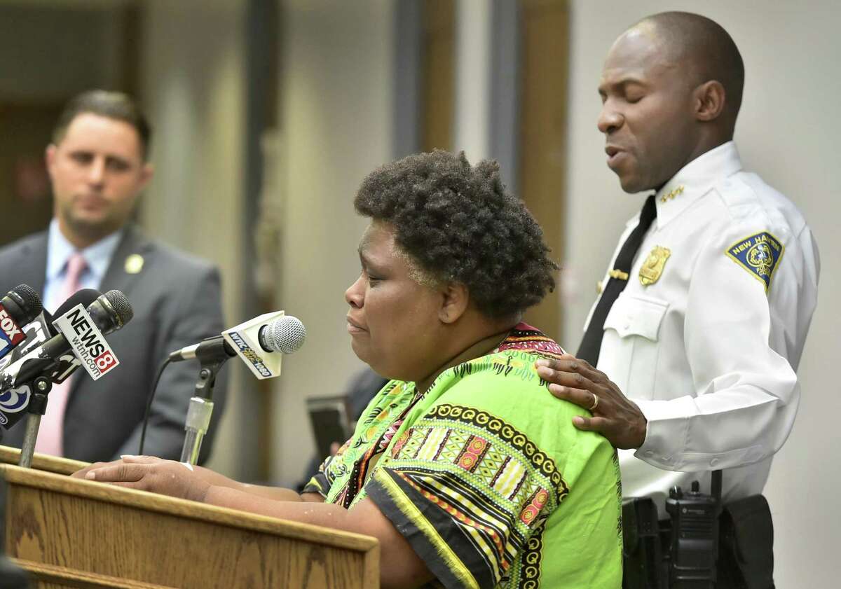 Demethra Telford of New Haven, center, talks about the July shooting death of her son Tyrick Keyes,14. At left is Detective Paul D’Andrea, lead detective in the investigation, and at right is Police Chief Anthony Campbell.
