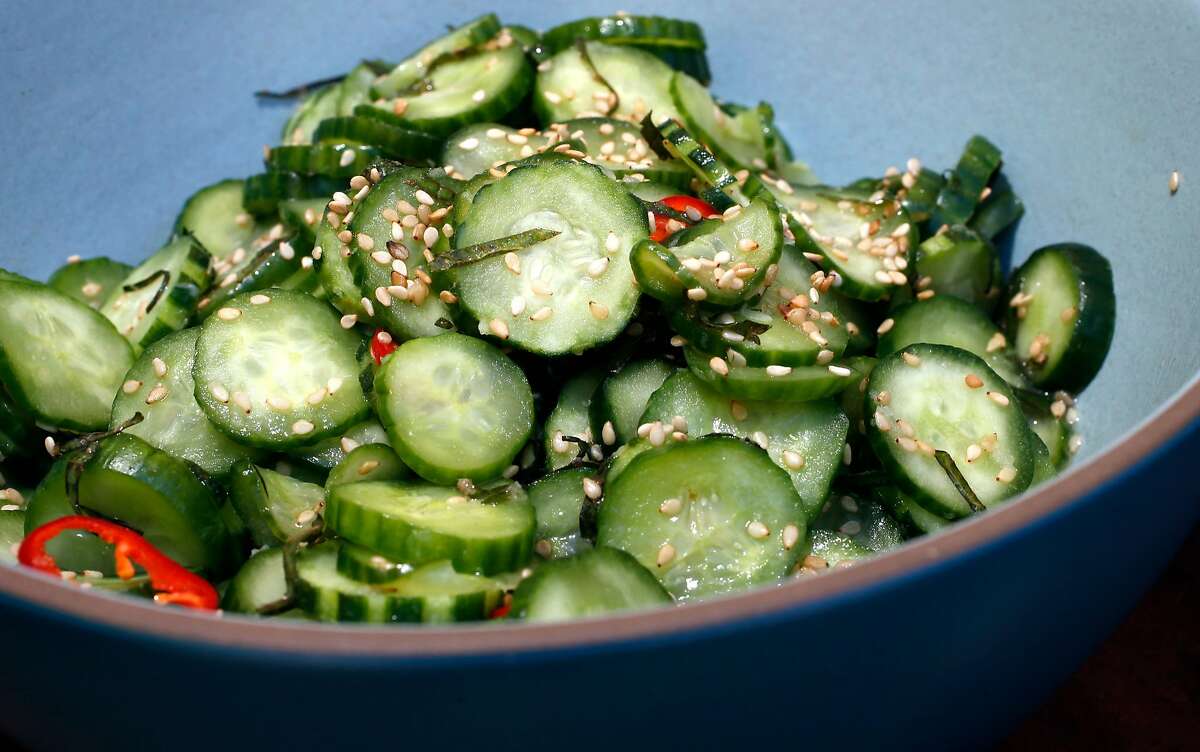 The chefs display the marinated cucumber salad, for a ssam. Chefs Julya Shin and Steve Joo the owners of a Korean ssam pop-up called Nokni, as seen on Mon. Sept.. 25, 2017, in Oakland, Ca.