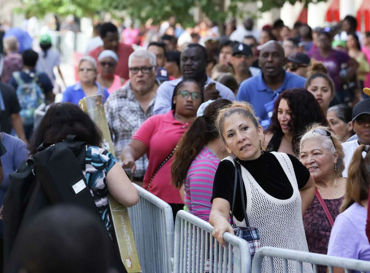 Thousands ﻿wait to apply for food assistance at the George R. Brown Convention Center﻿ on Oct. 6. More than 932,00 Harris County residents have received help.