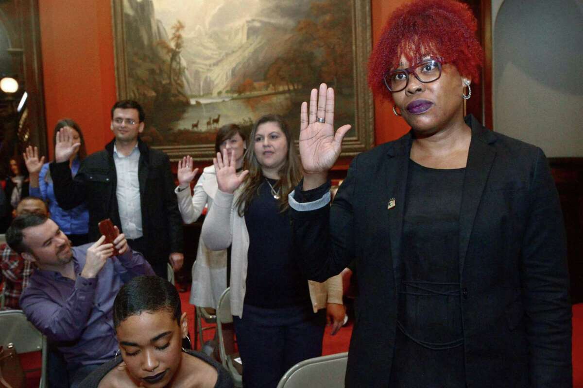 Branford resident and Trinidad and Tobago native, Michelle Welsh, right, participates in the swearing-in during a Special Naturalization Ceremony Tuesday, Oct. 17, at the Lockwood-Mathews Mansion Museum in Norwalk.