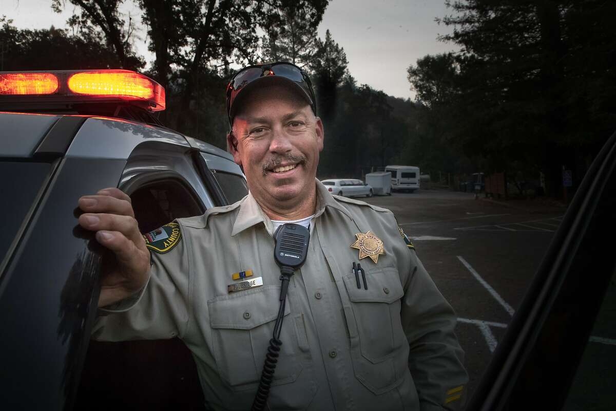 Deputy Mark Aldridge, who saved 35 people at this parking lot during the fire, pose on Tuesday, Oct. 17, 2017 in Santa Rosa, CA.
