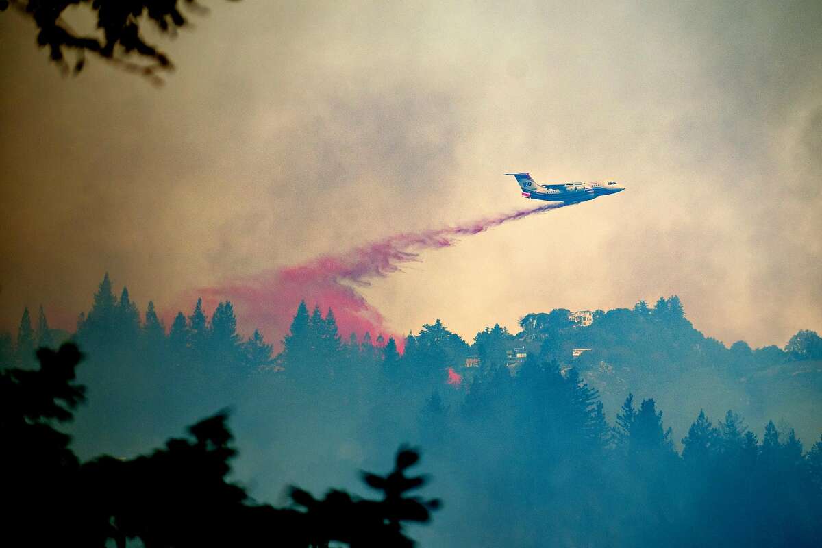 A tanker drops retardant on the Bear Bear fire in Boulder Creek, Calif., on Tuesday, Oct. 17, 2017.