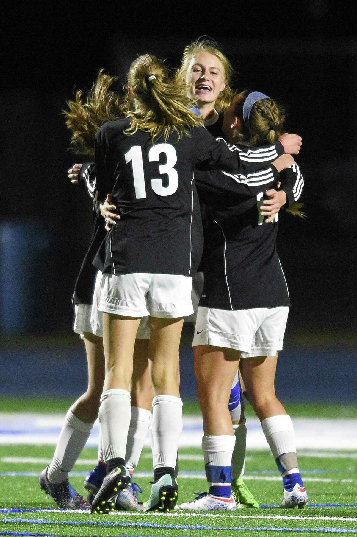 Darien Katie Ramsay (10), center, celebrates her game winning goal against Westhill with teammates Tuesday. Darien defeated Westhill 1-0.